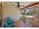 Cozy front porch featuring blue patio chairs, tile flooring, and a ceiling fan at 2028 Lake Christie Dr, Orlando, FL 32809