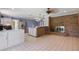 Open-concept kitchen with brick fireplace and a breakfast bar at 2028 Lake Christie Dr, Orlando, FL 32809
