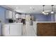 Bright kitchen featuring white cabinets, stainless steel appliances, and a breakfast bar at 2028 Lake Christie Dr, Orlando, FL 32809