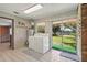 Bright laundry room featuring a washer, dryer, and view of the water at 2028 Lake Christie Dr, Orlando, FL 32809
