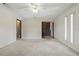 Spacious living room featuring neutral walls, carpeting, and a ceiling fan at 2028 Lake Christie Dr, Orlando, FL 32809
