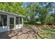 Backyard featuring a wood deck, glass doors that lead to the sunroom, and lush green foliage at 216 San Fernando Ct, Sanford, FL 32773