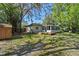 Exterior shot showcasing a deck, sunroom, shed, and a spacious yard with mature trees at 216 San Fernando Ct, Sanford, FL 32773