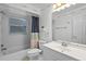 Bright bathroom with a shower and tub, featuring white fixtures and vanity with a large mirror at 216 San Fernando Ct, Sanford, FL 32773