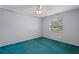 Neutral bedroom with a ceiling fan, window with blinds, and plush carpet at 216 San Fernando Ct, Sanford, FL 32773