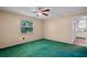 A spacious bedroom with a ceiling fan, a window and a door to the kitchen at 216 San Fernando Ct, Sanford, FL 32773