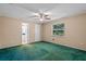 A spacious bedroom with a ceiling fan, a window and two doors to other rooms of the house at 216 San Fernando Ct, Sanford, FL 32773