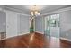 The dining room with hardwood floors, with a sliding glass door, a chandelier and entrance to the adjacent room at 216 San Fernando Ct, Sanford, FL 32773