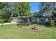 Inviting single-story home featuring a green lawn, mature trees, and attached two-car garage at 216 San Fernando Ct, Sanford, FL 32773