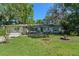 Well-maintained single-story residence with a beautiful lawn, trees, and an attached garage at 216 San Fernando Ct, Sanford, FL 32773