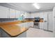 Functional kitchen with white cabinets, wood-look countertops, and modern appliances at 216 San Fernando Ct, Sanford, FL 32773