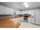 Practical kitchen featuring white cabinets, modern appliances, and a convenient layout at 216 San Fernando Ct, Sanford, FL 32773