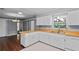 An open kitchen with white cabinets, wooden countertop with double sink and view to the dining and sliding glass door at 216 San Fernando Ct, Sanford, FL 32773