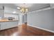 View of an open plan kitchen with white cabinets, wooden countertop and stainless steel appliances from the dining room at 216 San Fernando Ct, Sanford, FL 32773