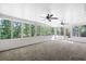 Bright sunroom with multiple windows, ceiling fans, and carpeted floor at 216 San Fernando Ct, Sanford, FL 32773