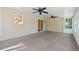 Bright sunroom features two ceiling fans, carpet, and view into the kitchen through a window at 216 San Fernando Ct, Sanford, FL 32773