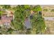 Aerial view of home, surrounded by green trees, featuring a long driveway and fenced in yard at 22 Hillcrest Dr, Babson Park, FL 33827