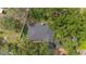 An aerial view captures the property, highlighting its tree coverage and fenced in boundaries at 22 Hillcrest Dr, Babson Park, FL 33827