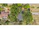 Aerial view of home, surrounded by green trees, featuring a long driveway and fenced in yard at 22 Hillcrest Dr, Babson Park, FL 33827