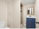 Tiled shower and blue vanity in updated bathroom at 22 Hillcrest Dr, Babson Park, FL 33827
