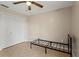Cozy bedroom featuring tile flooring, neutral walls, ceiling fan and a spacious closet for storage at 22 Hillcrest Dr, Babson Park, FL 33827