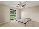 Bright bedroom with ceiling fan, neutral walls and a large window offering views of the outdoors at 22 Hillcrest Dr, Babson Park, FL 33827