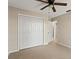 Spacious bedroom with neutral walls, ceiling fan, tile flooring and door to closet and restroom at 22 Hillcrest Dr, Babson Park, FL 33827