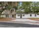 Charming one-story home featuring a freshly painted exterior and mature trees at 22 Hillcrest Dr, Babson Park, FL 33827