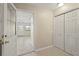 Hallway with tile flooring leading to various rooms, offering a glimpse of the home's layout at 22 Hillcrest Dr, Babson Park, FL 33827