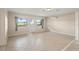 Bright room with tile flooring, multiple windows for natural light, and a door for easy access at 22 Hillcrest Dr, Babson Park, FL 33827