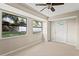 Bright room with a tile floor, two windows offering natural light, and access to the backyard at 22 Hillcrest Dr, Babson Park, FL 33827