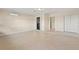 Open room with tile flooring, an AC unit, and access to a laundry room and other areas of the home at 22 Hillcrest Dr, Babson Park, FL 33827