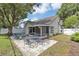 Backyard featuring an outdoor patio and seating area, screened-in porch, and partially fenced yard at 2227 Doulton Dr, Orlando, FL 32812