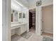 This bathroom features tile flooring, a vanity, and access to a closet at 2227 Doulton Dr, Orlando, FL 32812