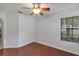 This bedroom features wood floors, a ceiling fan, and a window with blinds at 2227 Doulton Dr, Orlando, FL 32812
