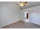 This bedroom features neutral carpet, a ceiling fan, and access to a bathroom at 2227 Doulton Dr, Orlando, FL 32812