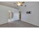 This bedroom features neutral carpet, a ceiling fan, and access to a bathroom and walk-in closet at 2227 Doulton Dr, Orlando, FL 32812