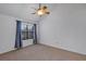 This bedroom has neutral carpet, a ceiling fan, and a window with curtains at 2227 Doulton Dr, Orlando, FL 32812