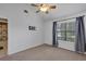This bedroom has neutral carpet, a ceiling fan, a window, and curtains at 2227 Doulton Dr, Orlando, FL 32812