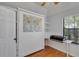 Stylish bedroom with Murphy bed, hardwood floors, built-in desk, shelves, and natural light at 2227 Doulton Dr, Orlando, FL 32812
