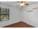 Bright, airy bedroom featuring wood floors, closet, and natural light from the window at 2227 Doulton Dr, Orlando, FL 32812