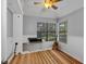 Clean bedroom with hardwood floors, built-in desk, guitar, and natural light from the windows at 2227 Doulton Dr, Orlando, FL 32812