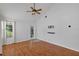 A spacious bedroom with wood-look floors, ceiling fan, and a door leading to the outside at 2227 Doulton Dr, Orlando, FL 32812