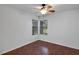 Cozy bedroom with wood laminate flooring, ceiling fan, and natural light at 2227 Doulton Dr, Orlando, FL 32812