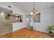 Dining area with wood floors, open to the kitchen, and filled with natural light at 2227 Doulton Dr, Orlando, FL 32812