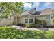 Inviting home exterior with sidewalk leading to the front door and landscaped yard at 2227 Doulton Dr, Orlando, FL 32812