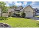 Charming single-story home with a well-manicured lawn and attached two-car garage at 2227 Doulton Dr, Orlando, FL 32812