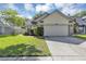 Well-maintained home with two-car garage, lush lawn, and neatly trimmed hedges at 2227 Doulton Dr, Orlando, FL 32812