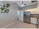 Well-lit kitchen featuring stainless steel refrigerator and a breakfast area at 2227 Doulton Dr, Orlando, FL 32812