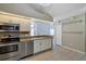 Efficient kitchen with stainless steel appliances, ample counter space, and easy access to dining area at 2227 Doulton Dr, Orlando, FL 32812